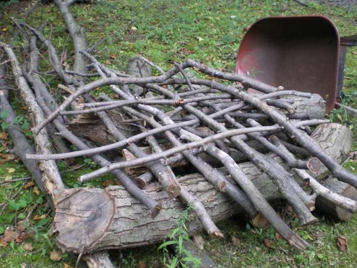 Interweave the branches at the base for a more stable pile. This method also leaves lots of room for birds to enter and explore.
