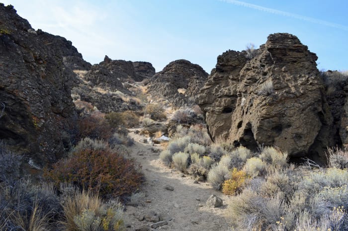 Hiking up the trail to the "Crack in the Wall" vista point overlooking south of Fort Rock. The trail is all sand.