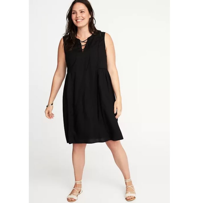 swing dress with rounded split neckline, lace up styling and eyelet trim at front yoke, seamed shirred back waist