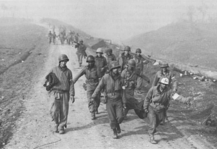 January 1944 - Medics from the 36th Infantry Division haul casualties away from the river crossing.