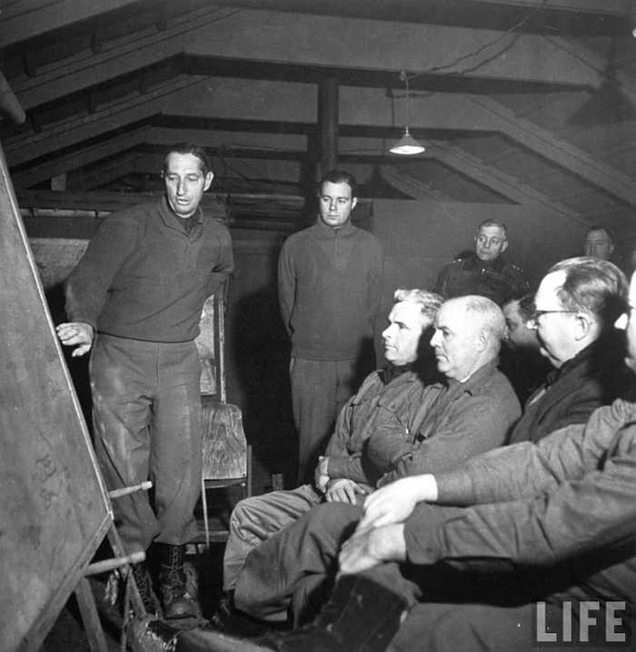 General Clark giving a briefing. Gen. Truscott is in the back, second from the right (leather jacket).