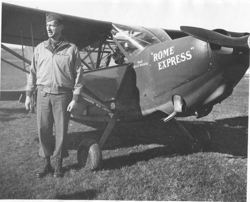 Clark beside his personal plane, 1944. His pilot, Lt. Col. John T. Walker, was killed in Feb. 1945 while flying home in a British transport plane.