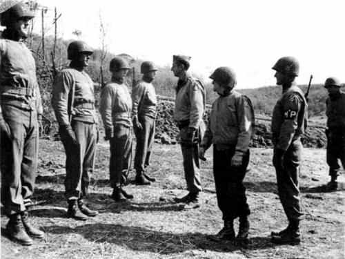 Gen. Clark inspecting 3rd ID soldiers near the Anzio beachhead. Gen. O'Daniel, 3rd ID CO is next to Clark.