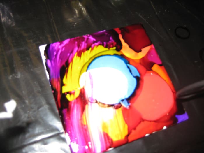 By simply pouring rubbing alcohol over the tile you can take a paper towel and wipe away the ink