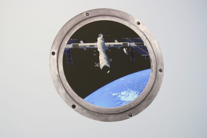 A space "porthole" wall decal ordered from Etsy. This decal cost approximately $13 and adds punch to the room.
