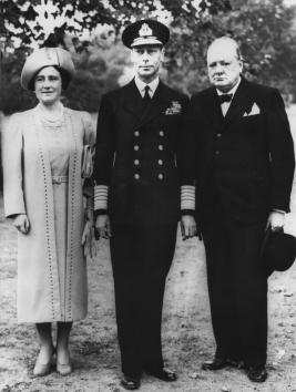 Britain's King George VI and Queen Elizabeth (the Queen Mother), accompanied by Prime Minister Winston Churchill, tour the grounds of Buckingham Palace on September 14, 1940, to inspect damage caused by German bombs that fell there.