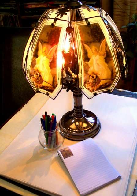 Writers are sometimes inspired by a pen, a pad, and a night lamp of floating angels.