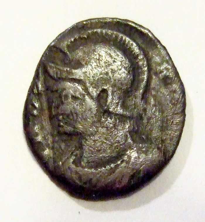 Helmeted portrait of Constantine the Great on this side of the coin, slightly larger but much thicker than a dime.