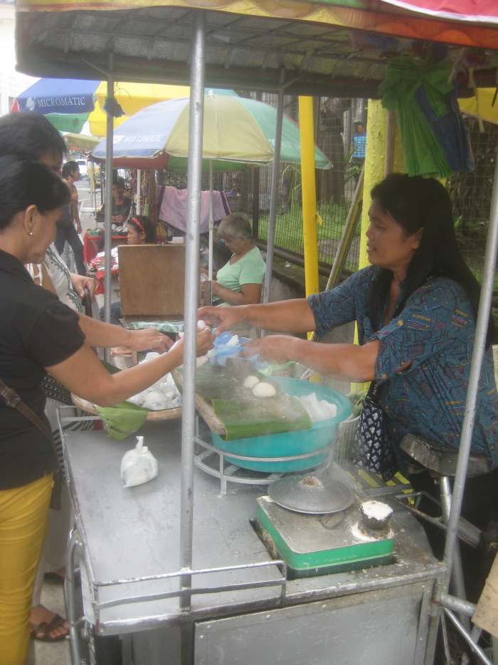 She's the only one selling rice cakes in Naga City, Bicol, Philippines, just outside the premises of San Francisco Church.