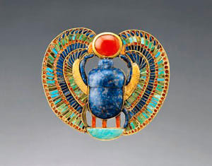 The scarab beetle in Egyptian jewellery symbolises rebirth, as the dung balls it creates form a birthing chamber for offspring. This pectoral was from the tomb of Tutankhamen.