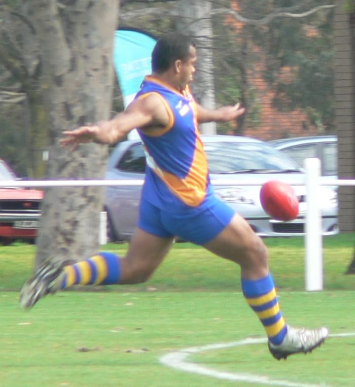 Man kicking a ball.