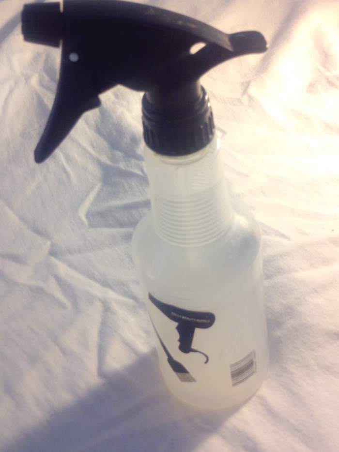 Most beauty supply stores, or departments within stores, will have spritz bottles you can pick up for a couple of bucks. Use them to spray just a little water to moisturize your hair each day.