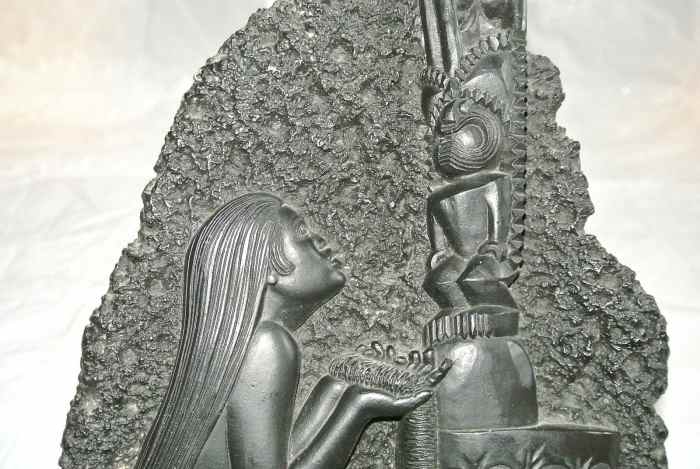 This beautifully made Coco Joe’s wall hanging is about 12 1/4 inches tall and about 7 inches wide. This shows a young Hawaiian women giving an offering to her Tiki for help and protection.