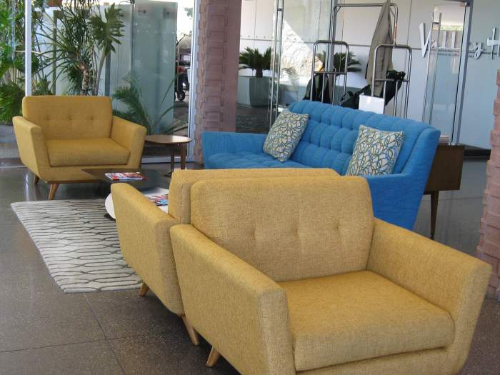 The big "ball" hanging light fixtures and Mid-Century modern furniture, rock walls, expanses of glass and a funky fireplace are typical of the 1950s.