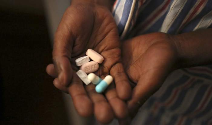 Nine-year-old Tumelo shows off antiretroviral pills before taking his medication at Nkosi's Haven, south of Johannesburg. Such anti-AIDS drugs are used as part of the cheap, illegal cocktail known as "nyaope."