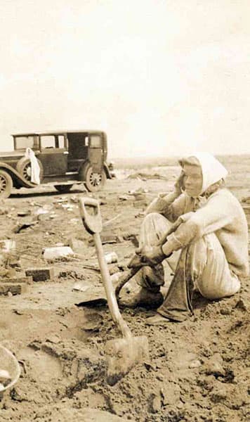 Hollywood actress, Katharine Hepburn, sitting in the muddy debris of her destroyed family beach home after the Great New England Hurricane of 1938