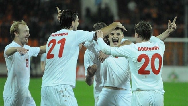 Yahor Filipenko (21) and Vitali Rodionov (20) celebrate with Stanislav Drahun during a 2014 World Cup match in October 2012.