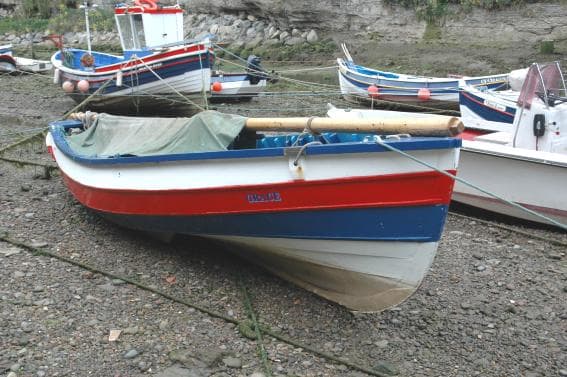Yorkshire coble in the creek at Staithes, low tide - the vessel's 'heritage' is shown in the sleek lines of its prow and 'waistline'