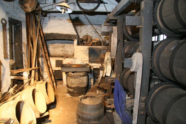The barrelling shop. this is where the needles were dried. The needles were placed in the barrels with hot sawdust from the stove.The barrels revolved by using the waterwheel.