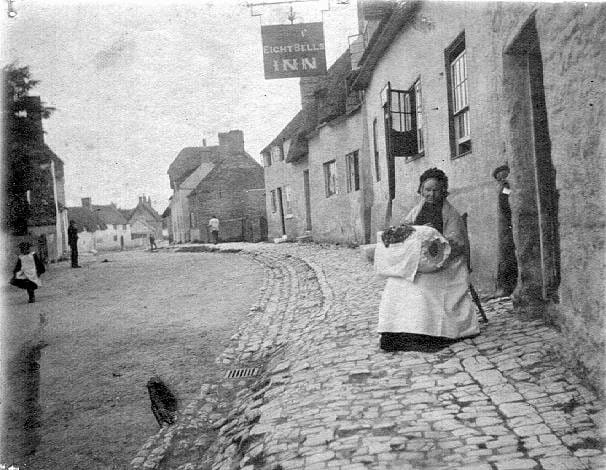 Lace maker outside a cottage in Long Crendon
