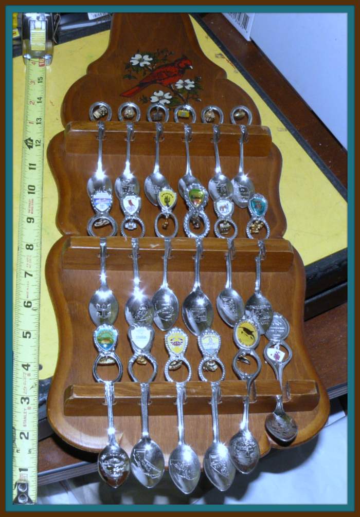 Here you have 18 beautiful Souvenir Spoons with charms and well made wood rack display ... This is a great collection of the US States & other locations.