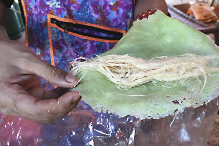 The 'roti saimai' prior to wrapping. Pandanus leaf extract provides the colouring