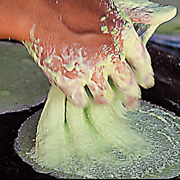 The preparation at a stall of 'roti saimai', a Thai cotton candy burrito pancake