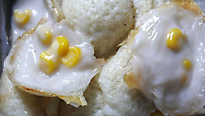 The coconut and rice pudding 'khanom krok'. The sweet corn topping is not strictly necessary, but adds visual attraction and texture. Since first writing this article I have sampled khanom krok many times and itis now my favourite Thai dessert