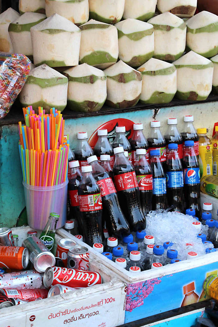 Drinks, Western and traditional. Behind the bottled water and the Coca Cola are the more authentically Thai coconuts