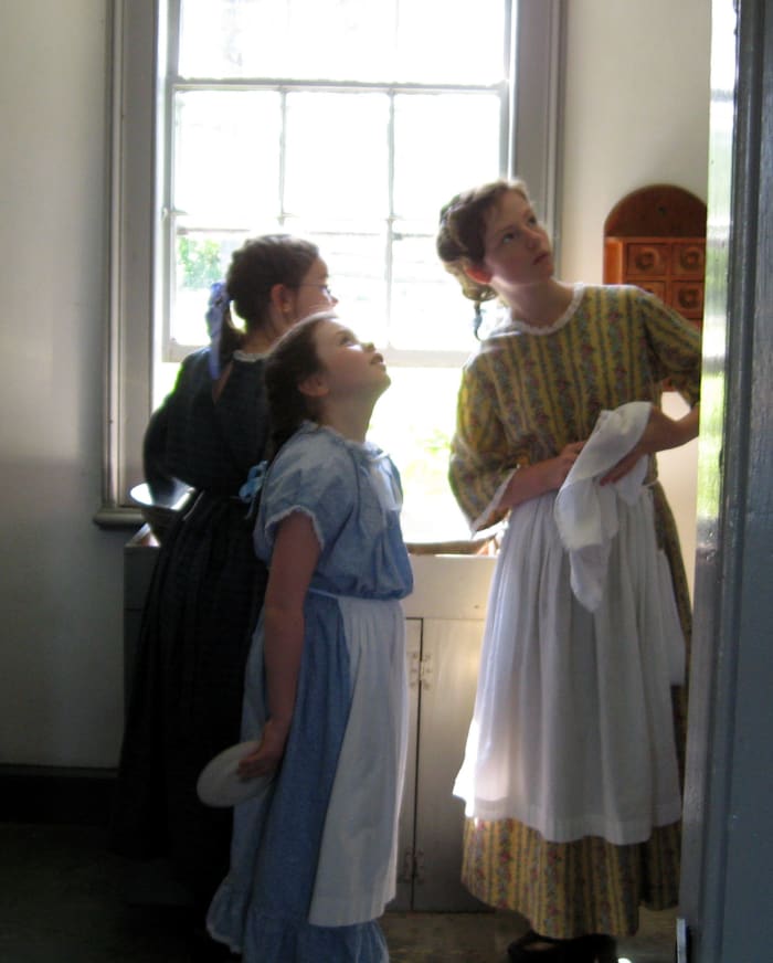 For girls, it can be a plain or flowered shirt, then a full skirt of Mom's will probably reach the floor on them. Cinch it with a belt or safety pins. For boys, plain slacks or jeans, make some pretend suspenders from belts.
