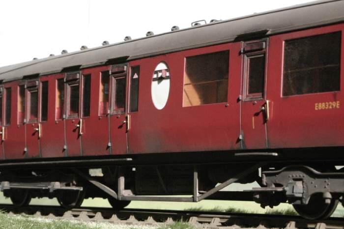 In British Railways plain crimson livery, Lavatory Composite Diagram 338 shows the central opaque oval toilet window with ventilation slider. The three 1st class compartments were at the near end (right)