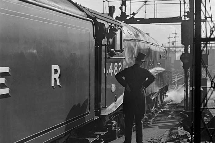 A4 No. 4482 'Golden Eagle' awaits the 'off' at King's Cross with the 'Flying Scotsman' service - top-hatted stationmaster in attendance