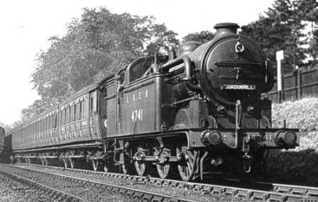 Ex-GNR Class N2 0-6-2 tank locomotive with condensing pipes passes with Gresley articulated suburban non-corridor stock. The pipes re-fed steam through the boiler and ensured no smoke was emitted in the tunnels between King's Cross and Moorgate