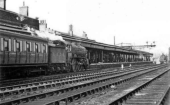 A 'Sandringham' class B17 with Gresley side corridora passenger stock at Cambridge, possibly arrived from London