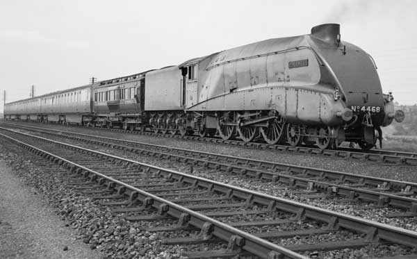 Class A4 4468 'Mallard' passes Barkston Junction on the ECML near Grantham in Lincolnshire with the York dynamometer carriage and one of the Silver jubilee sets on 3rd July 1938 to tackle her record-breaking run