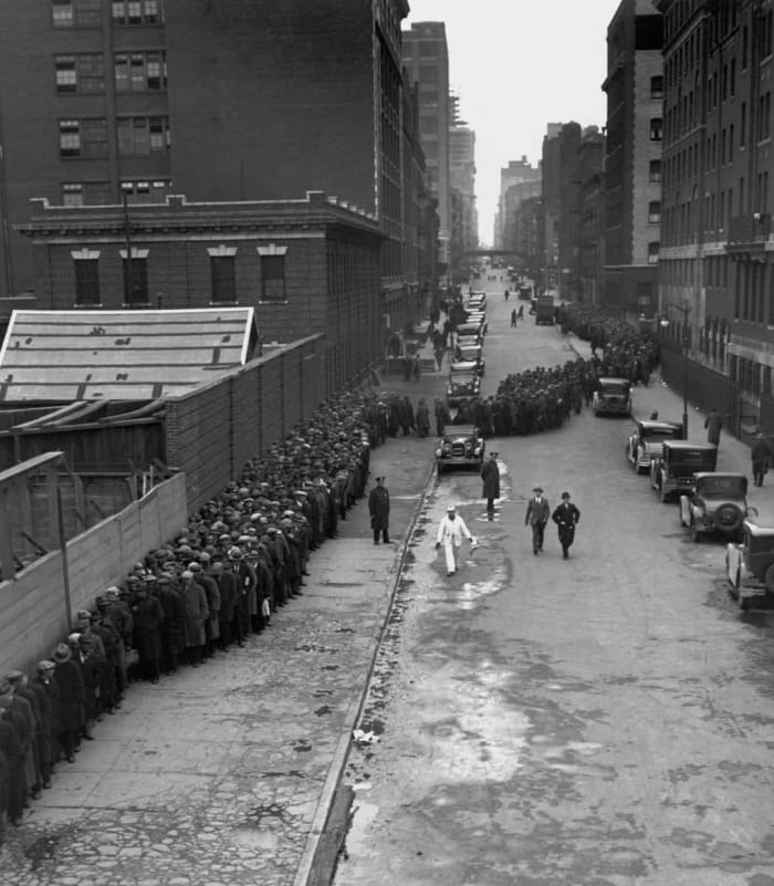 Hundreds of people line up for the free Christmas dinner at the New York Municipal Lodging House during the Great Depression December 25, 1931.