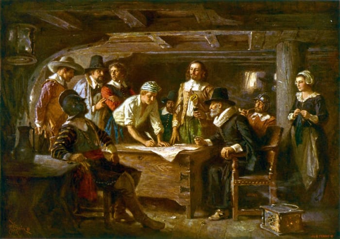 The painting “Mayflower Compact” by Jean Ferris depicts passengers of the Mayflower signing the Mayflower Compact