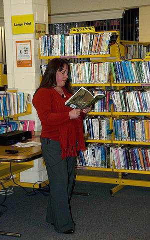 Photo from "Words from Wordsmiths" showing Adele Cosgrove-Bray reading her ghost story, "Seagull Inn", from the anthology "Ruins Terra."
