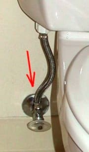 Red arrow points to the connection nut at the supply valve. There is a 2nd connection at the base of the toilet tank (visible in photo).