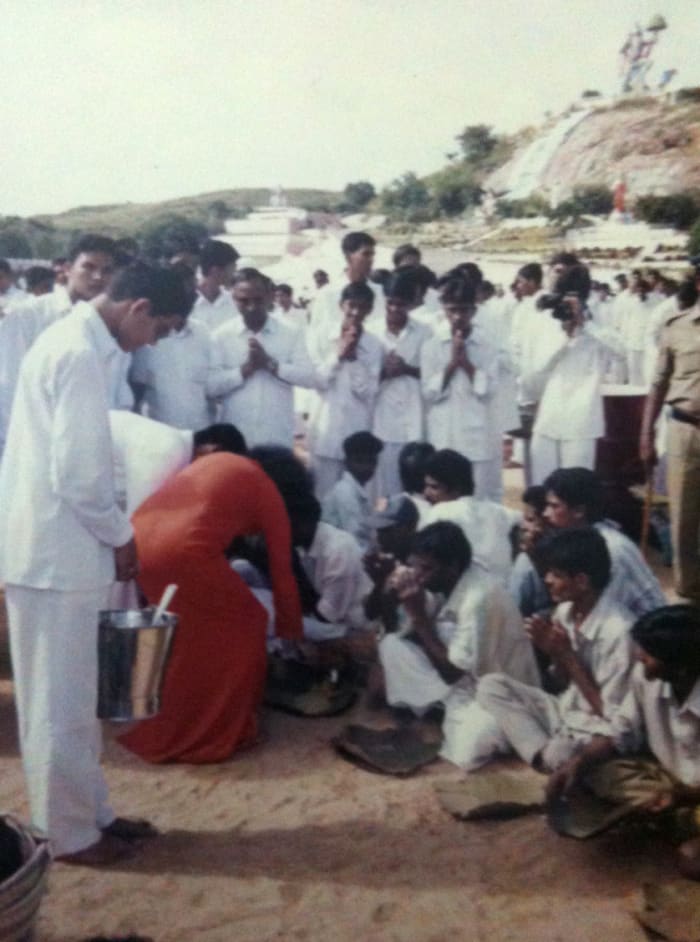 I enjoyed the privilege of taking photos as well on that Narayan Seva day. (Seen in this picture, opposite to Swami with a camera to my face!)