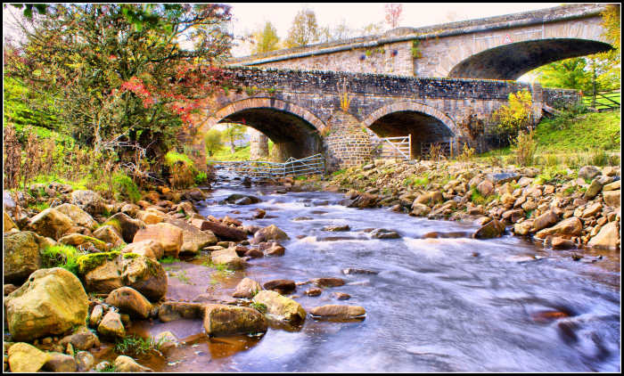 The Burnstones bridges where the A689 met the railway, with the viaduct towering over it behind