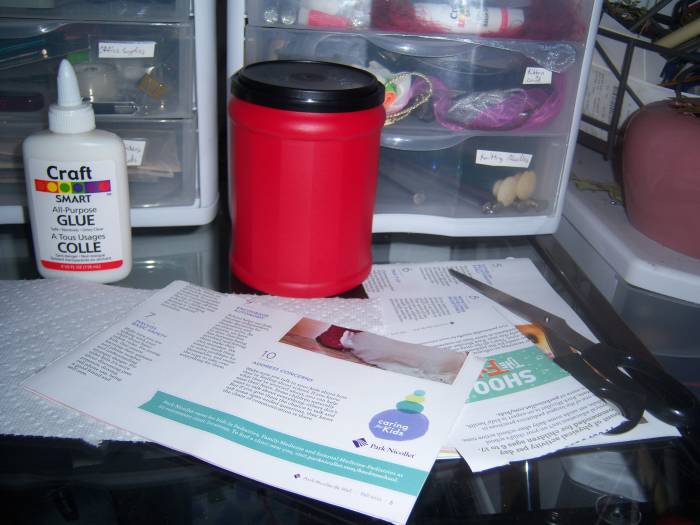 My basic supplies - an empty and clean coffee can, scissors, a cut up magazine and bottle of glue.