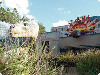 Aladar, the Iguanadon from Dinosaur the movie, in front of the entrance to DINOSAUR the ride.
