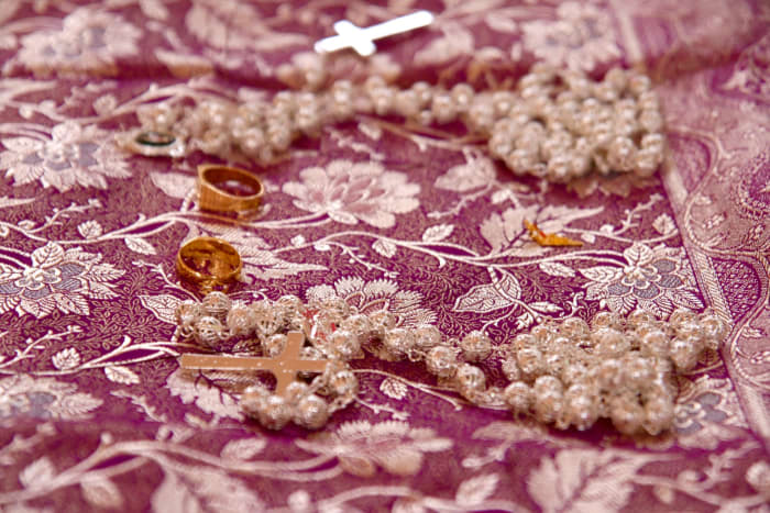 Mathrakoodi ( the wedding saree), the wedding rings, Thali and the Roasary kept for blessing, during the marriage