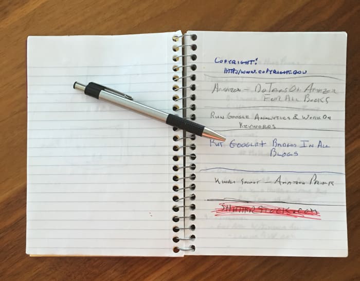 Pen and Paper filled with notes, are common tools of a writer.. Even in the electronic age, a writer needs to keep copious notes as their works evolve.