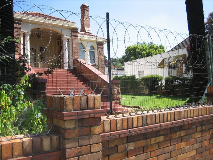 The sign that said "YOU HAVE BEEN WARNED" is a warning to the reader and to the family which the fence aimed to protect in Nadine Gordimer's "Once Upon A Time."