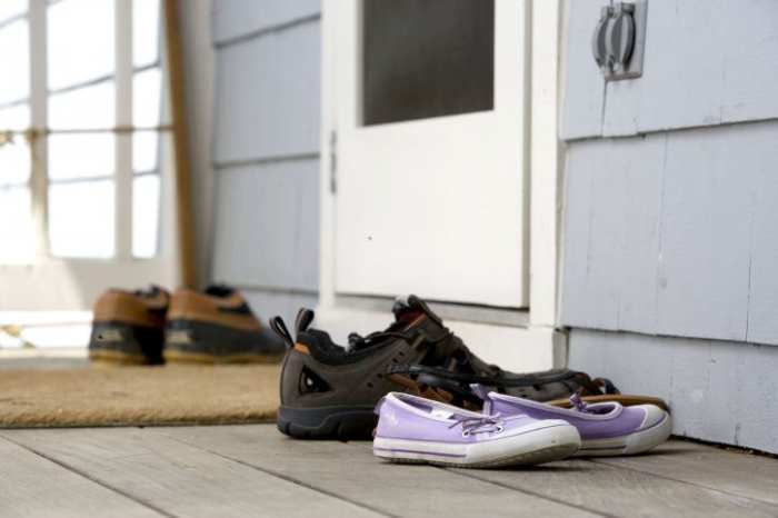 The best practice you can institute is to ask everyone to remove their shoes before entering the house to reduce the risk of bringing contaminants into the home. Clean shoes with a sanitizing shoe mat, sanitizer wipes or a sanitizer sprayed on the