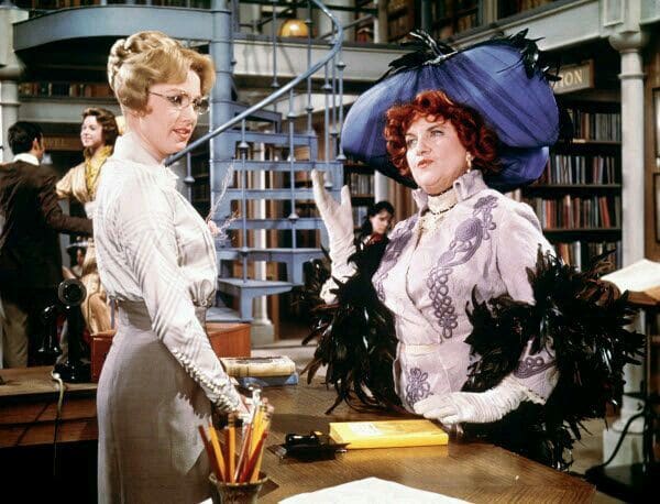 Mrs. Shinn confronting Marian, the librarian over the quality of the books she has in the library. Shirley Jones and Hermoine Gingold