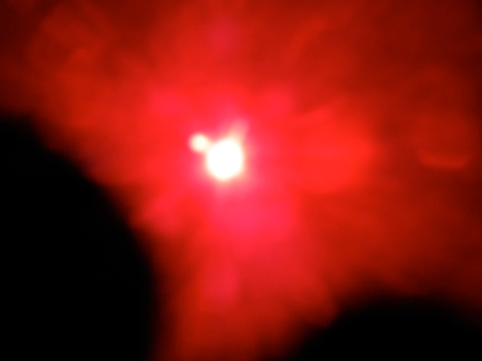 The two black areas are my fingers holding the filters in place, the orb at the 10 O'clock position looks suspiciously like a planet next to our Sun.