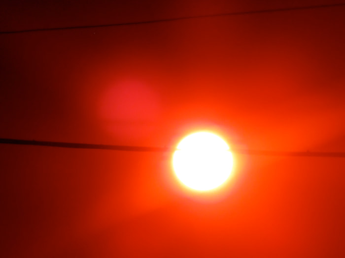 Taking pictures of the Sun this evening I was lucky enough to get this one clearly showing Swamp Gas. Notice the sphere to the upper left of the Sun?